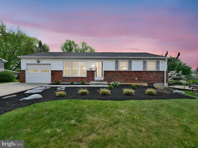 ranch-style home featuring concrete driveway, brick siding, a front yard, and a garage