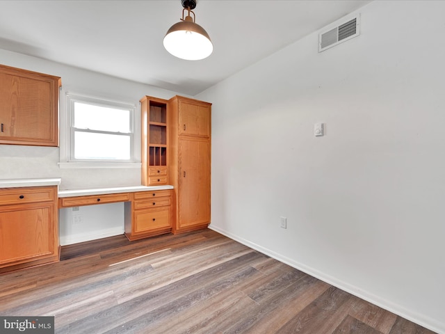 218 W Franklin Ave, Myerstown, PA 17067 - unfurnished office featuring visible vents, baseboards, built in study area, and wood finished floors