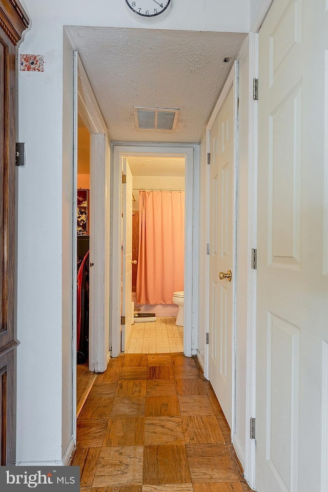 7202 Good Luck Rd, Lanham, MD 20706 - hallway featuring a textured ceiling and light flooring