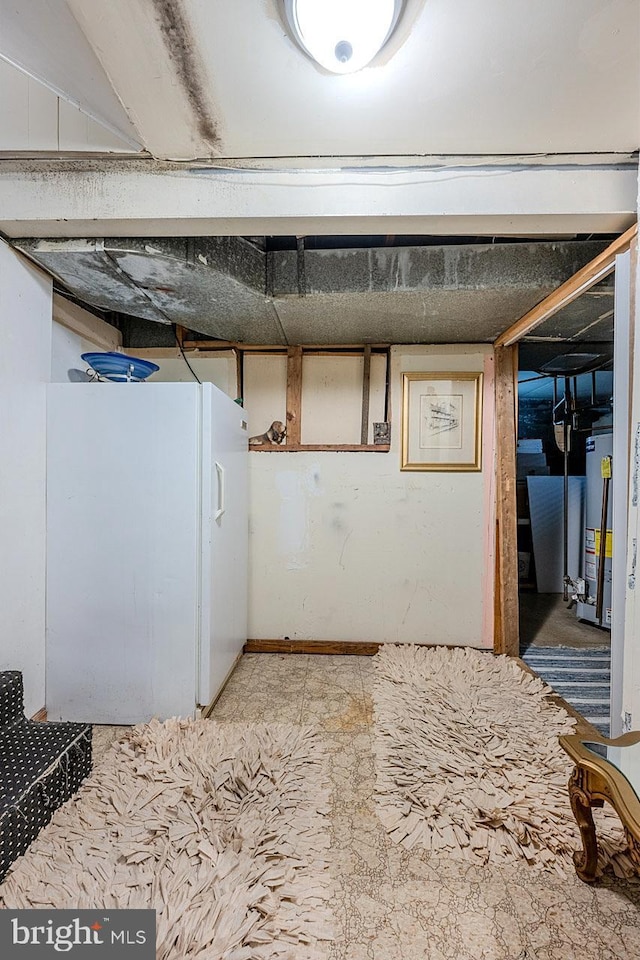 7202 Good Luck Rd, Lanham, MD 20706 - finished below grade area featuring gas water heater and freestanding refrigerator