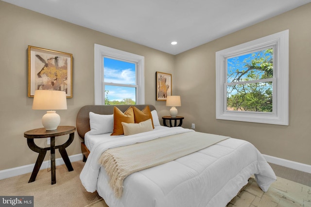 bedroom featuring baseboards, recessed lighting, and light carpet