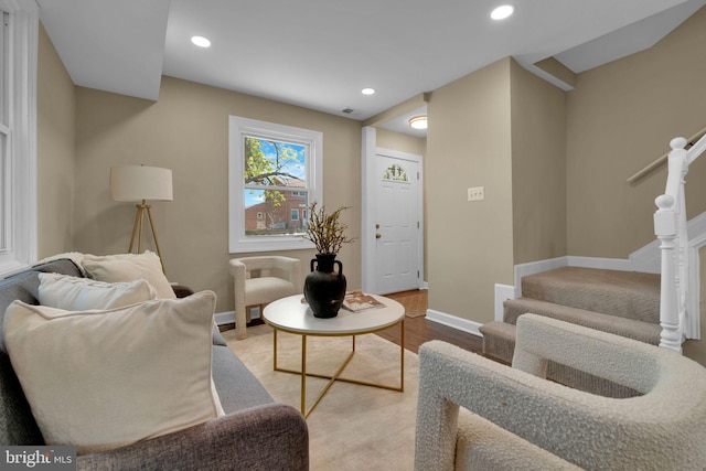 living room with recessed lighting, baseboards, stairs, and wood finished floors