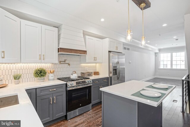 2326 Gerritt St, Philadelphia, PA 19146 - kitchen with gray cabinets, visible vents, crown molding, premium range hood, and stainless steel appliances