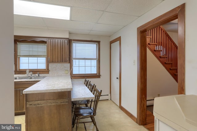 350 E Derry Rd, Hershey, PA 17033 - kitchen with a sink, a kitchen breakfast bar, a paneled ceiling, light countertops, and plenty of natural light