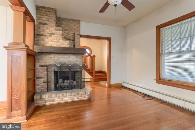 350 E Derry Rd, Hershey, PA 17033 - unfurnished living room featuring a baseboard radiator, hardwood / wood-style floors, a ceiling fan, and baseboards