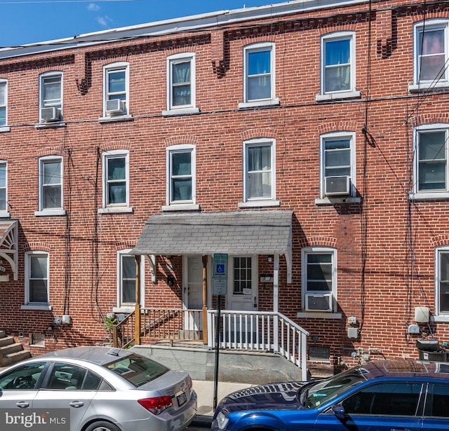 townhome / multi-family property featuring brick siding and cooling unit