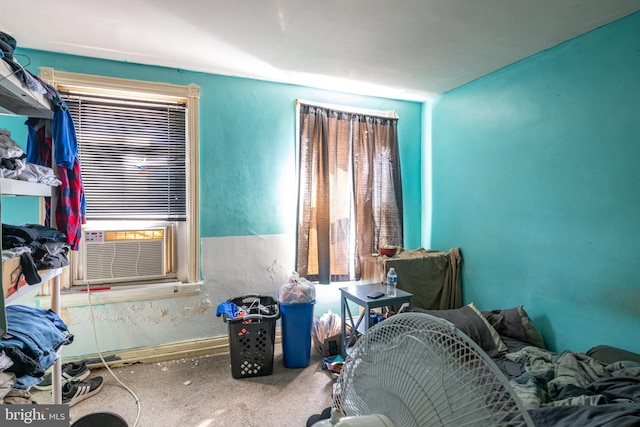 carpeted bedroom with baseboards and cooling unit