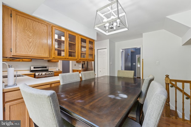 dining space with dark wood-type flooring and a notable chandelier