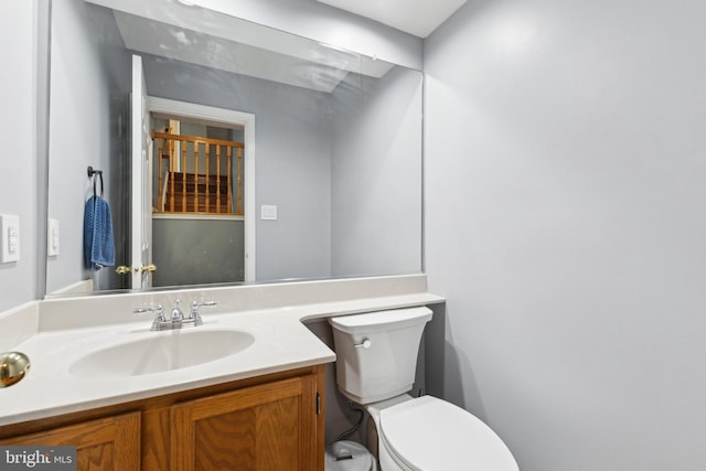 half bath with vanity and toilet