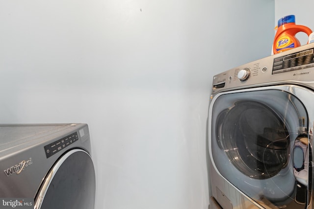 laundry room featuring separate washer and dryer and laundry area