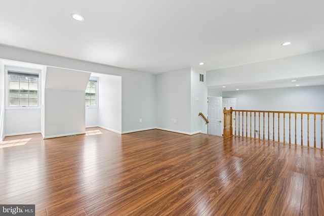 empty room featuring baseboards, recessed lighting, wood finished floors, and visible vents