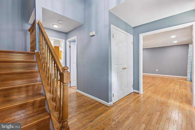 stairway with baseboards and hardwood / wood-style floors