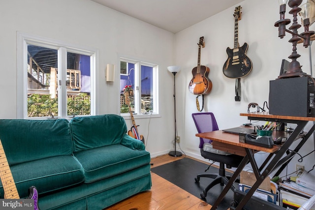 office space featuring baseboards and wood finished floors
