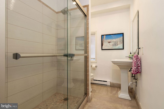 full bathroom featuring baseboards, a baseboard radiator, a shower stall, and toilet
