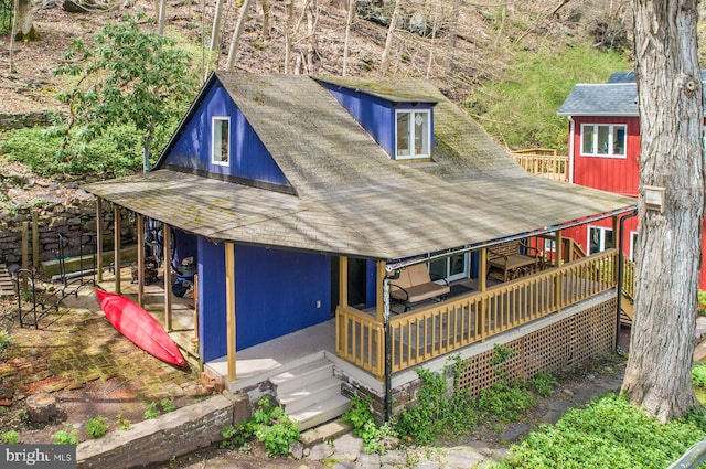 exterior space with roof with shingles