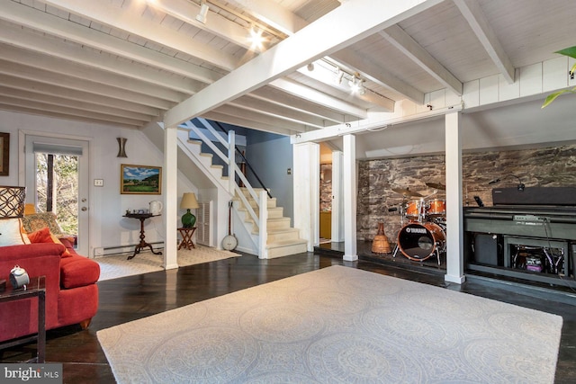 below grade area with track lighting, baseboard heating, stairs, wood finished floors, and wood ceiling