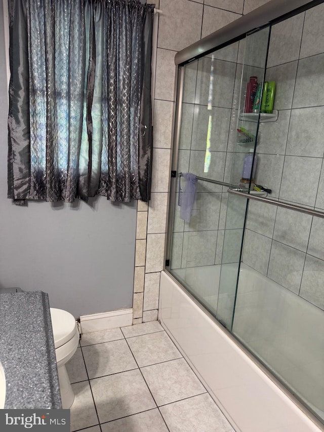 603 Leuckel Ave, Hamilton, NJ 08619 - full bathroom featuring combined bath / shower with glass door, tile patterned floors, and toilet