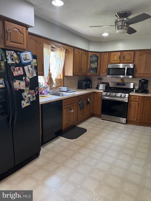 603 Leuckel Ave, Hamilton, NJ 08619 - kitchen with brown cabinetry, a sink, a ceiling fan, and black appliances