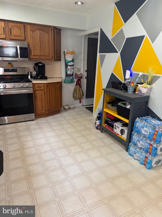 603 Leuckel Ave, Hamilton, NJ 08619 - kitchen featuring light countertops, light floors, brown cabinetry, and stainless steel appliances