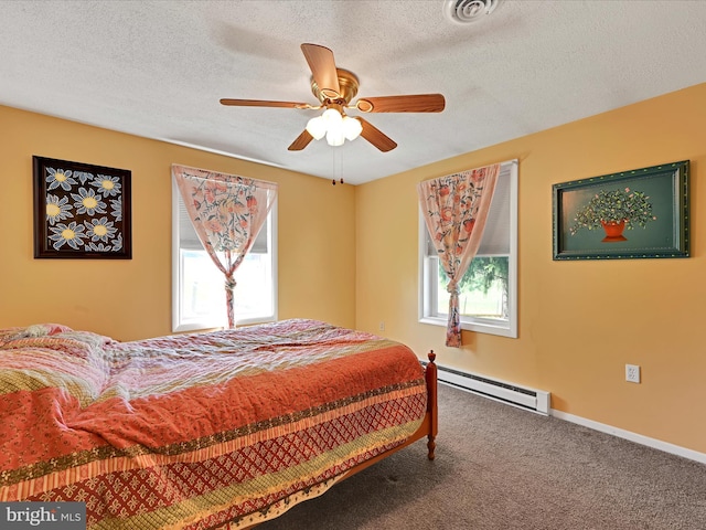 917 Houtztown Rd, Myerstown, PA 17067 - carpeted bedroom with a textured ceiling, a baseboard heating unit, ceiling fan, and visible vents