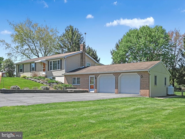 917 Houtztown Rd, Myerstown, PA 17067 - view of front of property with brick siding, a garage, a front yard, a chimney, and driveway