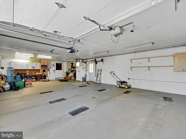 917 Houtztown Rd, Myerstown, PA 17067 - garage featuring a garage door opener and freestanding refrigerator
