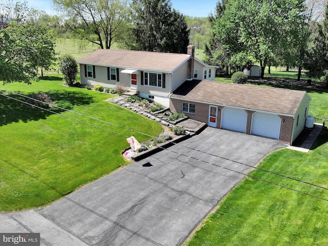 917 Houtztown Rd, Myerstown, PA 17067 - view of front of house featuring a chimney, an outdoor structure, a shed, aphalt driveway, and an attached garage