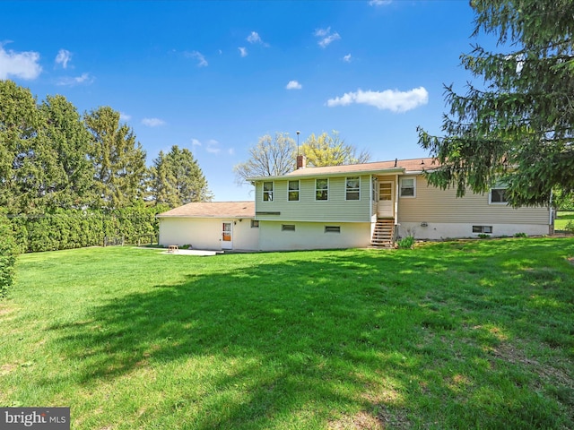 917 Houtztown Rd, Myerstown, PA 17067 - rear view of property featuring entry steps, a chimney, and a lawn