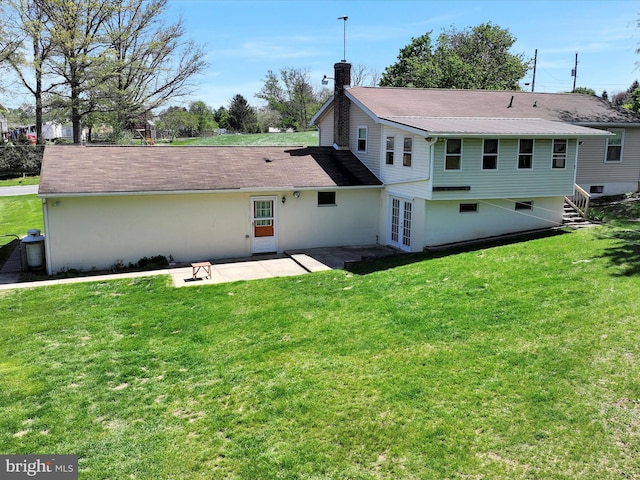 917 Houtztown Rd, Myerstown, PA 17067 - rear view of house featuring a lawn, a patio, a chimney, and french doors