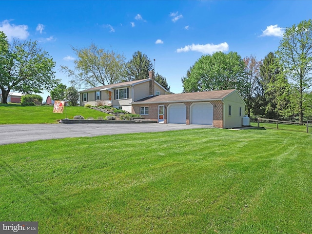 917 Houtztown Rd, Myerstown, PA 17067 - view of front of home featuring a garage, fence, a front yard, brick siding, and driveway