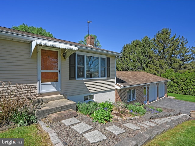 917 Houtztown Rd, Myerstown, PA 17067 - view of front of house with entry steps, a chimney, and a garage