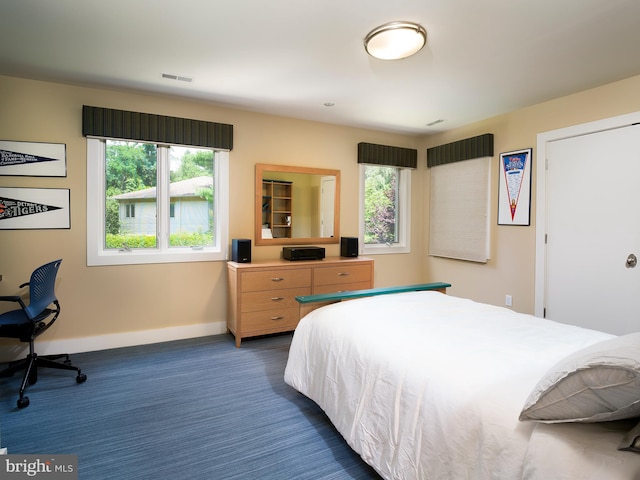 bedroom featuring baseboards, multiple windows, carpet, and visible vents