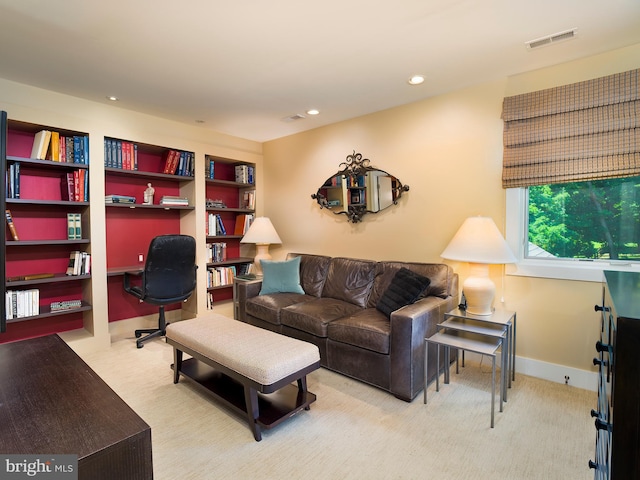 carpeted living area with recessed lighting and visible vents