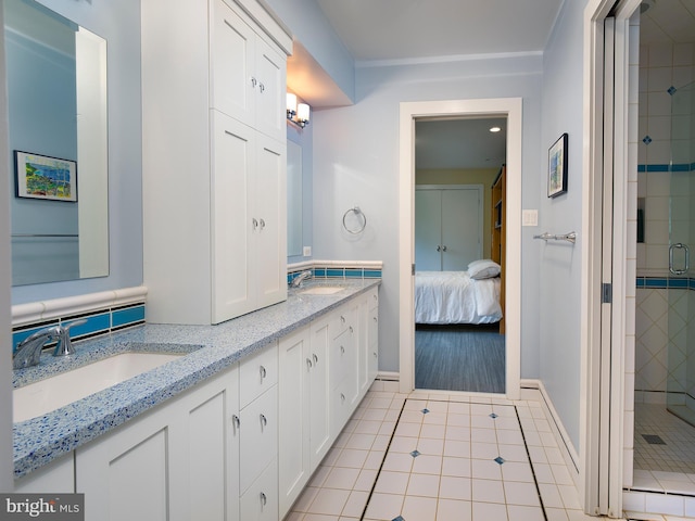full bath featuring a sink, tile patterned flooring, and a stall shower