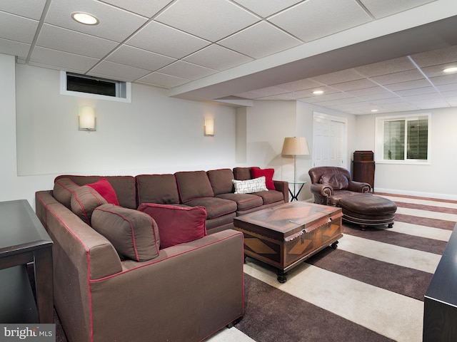 carpeted living area with recessed lighting and a paneled ceiling