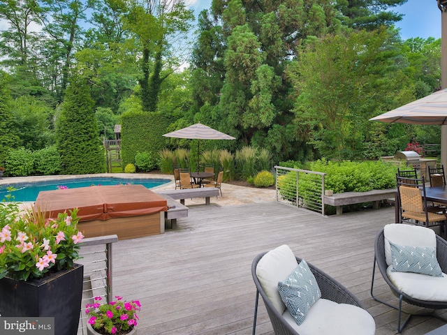 exterior space with a jacuzzi, outdoor dining space, and an outdoor pool