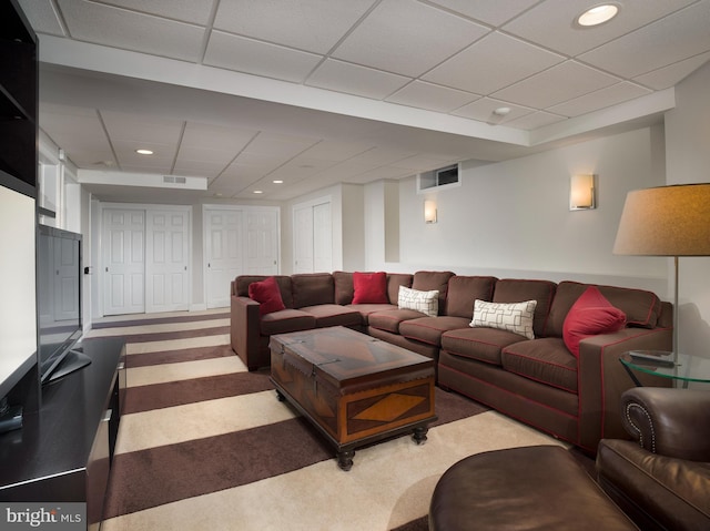 living area featuring carpet flooring, recessed lighting, visible vents, and a drop ceiling