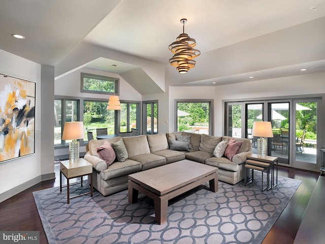 living room featuring dark wood-style flooring, vaulted ceiling, a healthy amount of sunlight, and recessed lighting