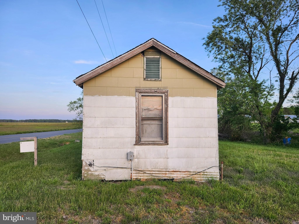 view of side of home featuring a yard