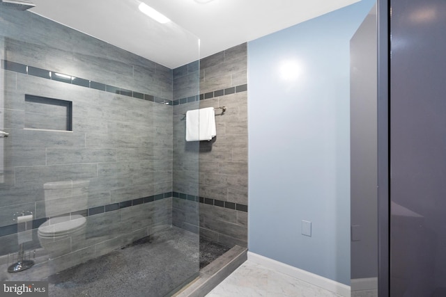 full bath with baseboards, a tile shower, and marble finish floor