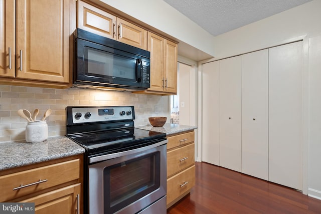 kitchen featuring backsplash, dark wood-style flooring, black microwave, light stone counters, and stainless steel electric stove