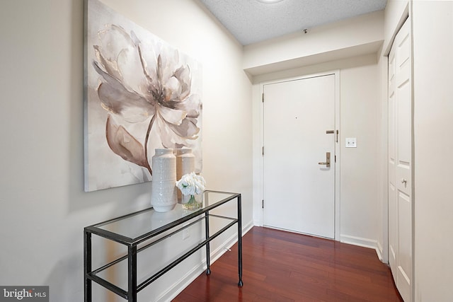 entryway featuring baseboards and wood finished floors
