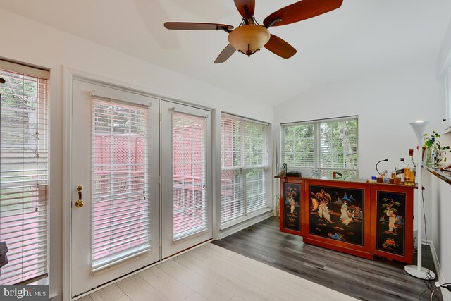 sunroom featuring lofted ceiling