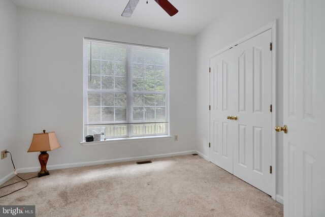 unfurnished bedroom with carpet, baseboards, and ceiling fan