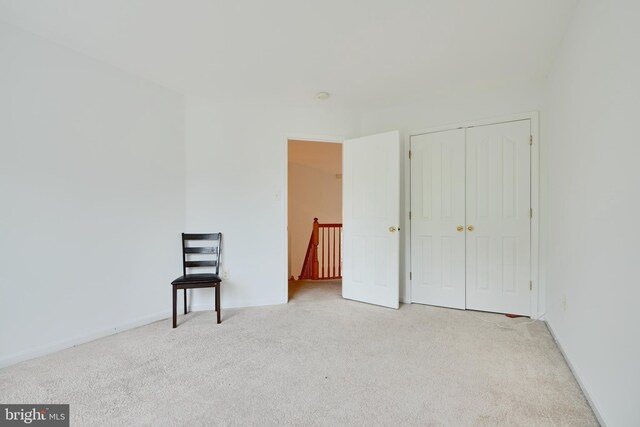 carpeted spare room featuring baseboards
