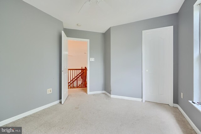 unfurnished bedroom featuring carpet and baseboards