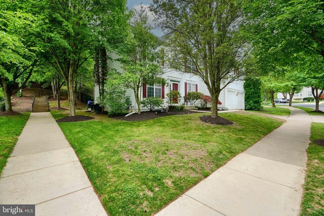 view of front of property featuring a front lawn and a garage