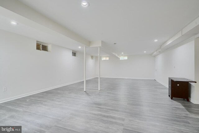 basement with baseboards, recessed lighting, and wood finished floors