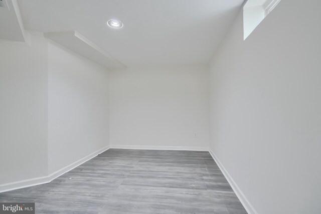 spare room with recessed lighting, wood finished floors, and baseboards