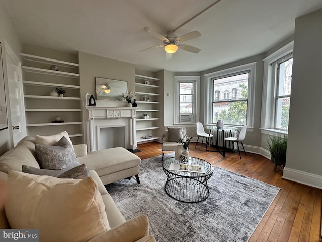1527 Park Rd NW Unit 302, Washington, DC 20010 - living area featuring a fireplace with flush hearth, hardwood / wood-style floors, baseboards, a ceiling fan, and built in shelves